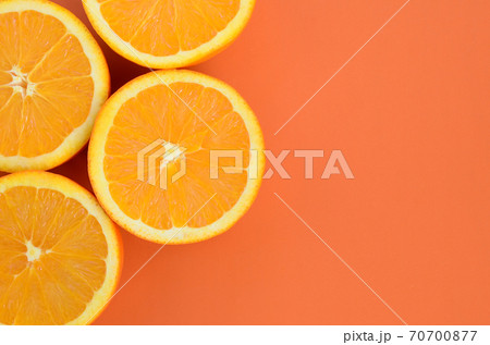 Top view of a several orange fruit slices on bright background in orange color. A saturated citrus texture image Top view of a several orange fruit slices on bright background in orange color. A saturated citrus texture image 70700877