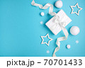 Christmas composition, gift box and white balls on blue background, minimalism. 70701433