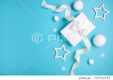 Christmas composition, gift box and white balls on blue background, minimalism. 70701433