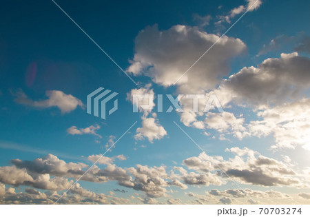 Dramatic evening summer or early autumn warm bright blue cloudy sky background. Dramatic evening summer or early autumn warm bright blue cloudy sky background. 70703274