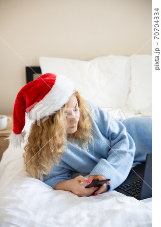 Woman with smartphone and laptop Woman with smartphone and laptop 70704334