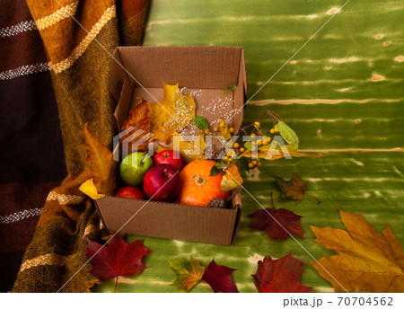 Autumn fall Halloween Thanksgiving season special post delivery box with fruits and vegetables apples pumpkin maple leaves and other decoration. Free blank copy space for text Autumn fall Halloween Thanksgiving season special post delivery box with fruits and vegetables apples pumpkin maple leaves and other decoration. Free blank copy space for text 70704562