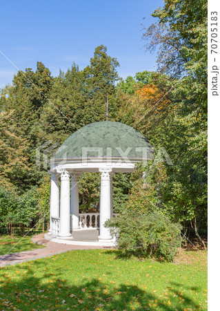 White stone garden house in a summer park White stone garden house in a summer park 70705183