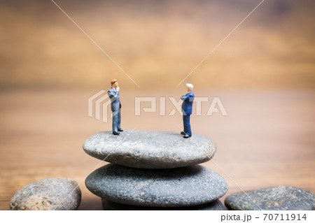 Miniature people : Businessman standing on stone , Challenges and risks Concept 70711914