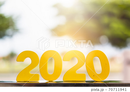 2020 text numbers on table with blurred tree background 70711941
