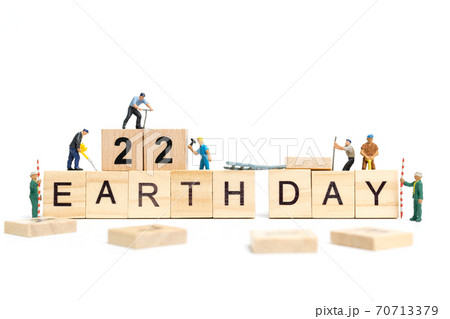 Miniature people : Worker team building word " Earth day " on wooden block with wooden background Miniature people : Worker team building word " Earth day " on wooden block with wooden background 70713379