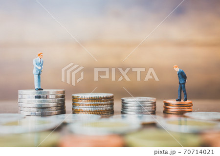 Miniature people businessman standing on money 70714021