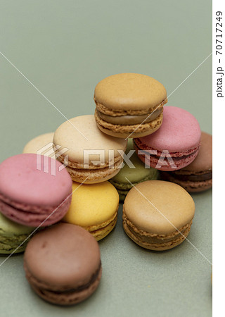 Colored tasty macaroons over a green background. Colored tasty macaroons over a green background. 70717249