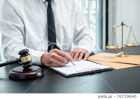 Male lawyer working with legal case document contract in office, law and justice, attorney, lawsuit concept Male lawyer working with legal case document contract in office, law and justice, attorney, lawsuit concept 70719640