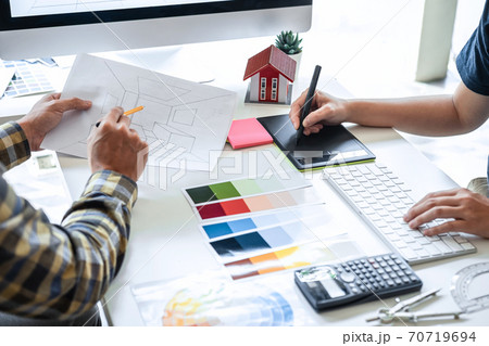 Team of young Interior graphic designer working sketching on graphic tablet and color swatch, discussing of house project at modern office, creative work place inspiration and imagine 70719694