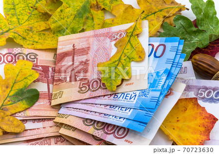 Russian money and autumn leaves, paper money and oak leaves, five thousand and two thousand rubles Russian money and autumn leaves, paper money and oak leaves, five thousand and two thousand rubles 70723630