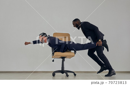 The businessmen playing with chair 70723813