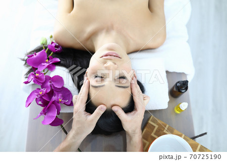 Portrait of woman who is being massaged closeup 70725190