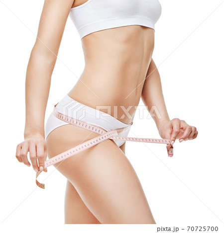 Slim tanned woman's body isolated on white background - waist measurement 70725700