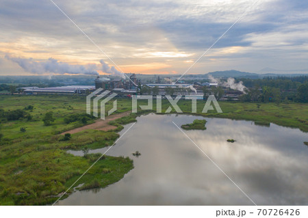 Aerial view of Mae Moh Coal Power Plant with smoke and toxic air from chimney. Factory industry. Electricity tower in energy or pollution environment concept. Lampang City, Thailand Aerial view of Mae Moh Coal Power Plant with smoke and toxic air from chimney. Factory industry. Electricity tower in energy or pollution environment concept. Lampang City, Thailand 70726426