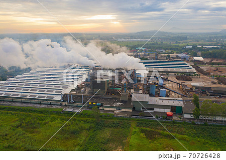 Aerial view of Mae Moh Coal Power Plant with smoke and toxic air from chimney. Factory industry. Electricity tower in energy or pollution environment concept. Lampang City, Thailand 70726428