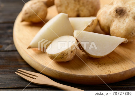 Sliced jicama or yam on chopping wooden board Sliced jicama or yam on chopping wooden board 70727886