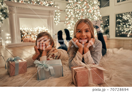 The happy girl and boy with gifts laying on the floor The happy girl and boy with gifts laying on the floor 70728694
