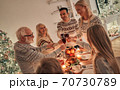 The happy family clinking glasses above the christmas table 70730789