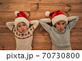 The kids in red hats laying on the floor 70730800