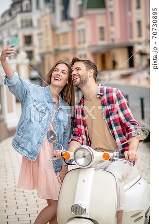Woman taking a selfie with her boyfriend 70730895