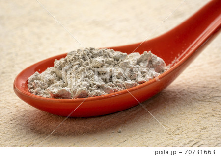 food grade diatomaceous earth supplement on a spoon 70731663