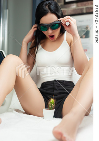 a woman in a laser hair removal Studio poses with a cactus a woman in a laser hair removal Studio poses with a cactus 70732633
