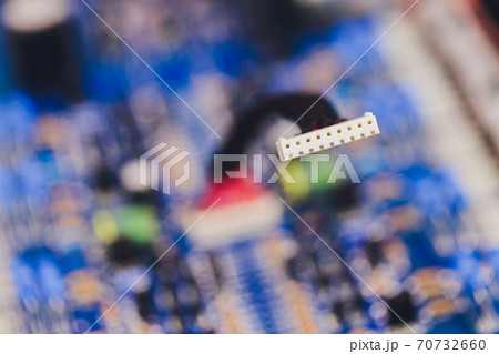 Closeup on electronic board in hardware repair shop, blurred and toned image. Shallow DOF, focus on the middle left field. 70732660