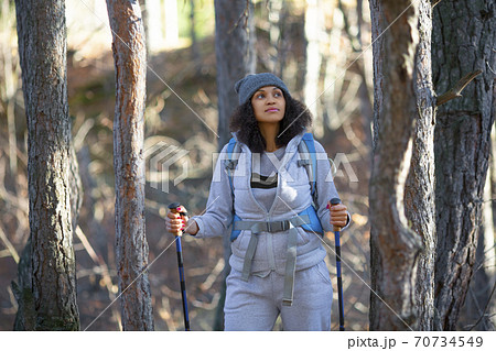 Photo of an African American woman walking through the forest. 70734549