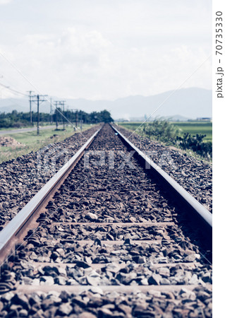 Railway tracks line forward gravel, horizon beauty cloudy blue sky, electric poles, landscape sun mountain background. Railroad travel tourism, transportation industrial concept summer evening 70735330
