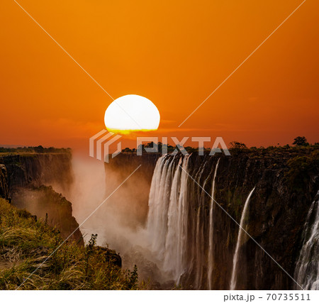 Supersized sun over Victoria Falls in Zambia Supersized sun over Victoria Falls in Zambia 70735511