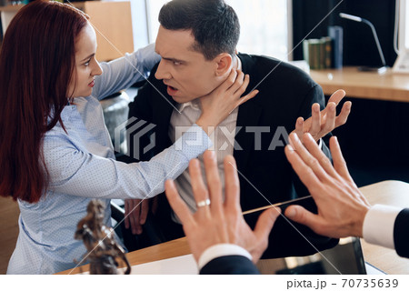 Woman strangles a man with her bare hands. Woman strangles a man with her bare hands. 70735639
