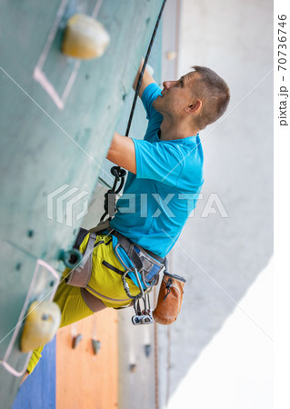 Young man climber on the climbing wall 70736746