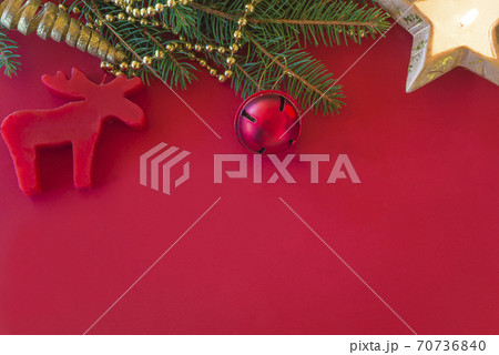 Template for christmas holiday greeting card. fir branch and christmas decoration on red background. Space for text, flat lay Template for christmas holiday greeting card. fir branch and christmas decoration on red background. Space for text, flat lay 70736840