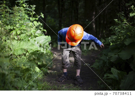 The child walks through the woods. The child walks through the woods. 70738411