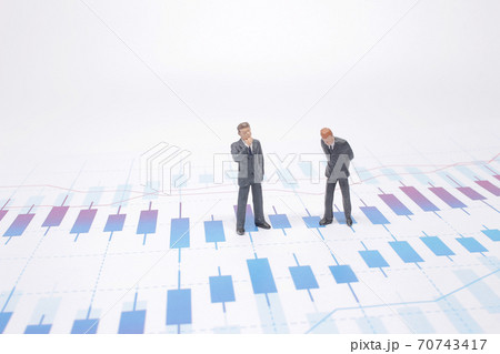 a Businessmen are skeptical looking at stock market charts. a Businessmen are skeptical looking at stock market charts. 70743417