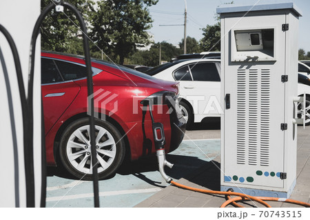Charging modern electric car on the parking. 70743515