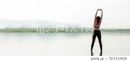 Lifestyle woman yoga exercise and worm up raise arm before pose for healthy life 70743908