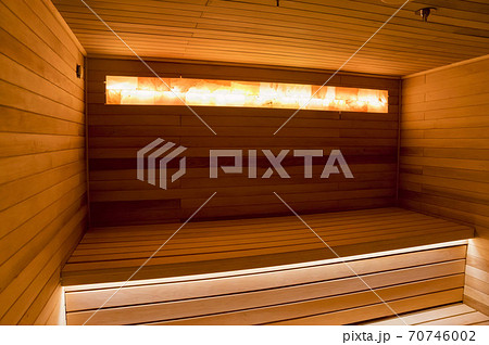 Empty wooden sauna interior with beutiful warm lightning Empty wooden sauna interior with beutiful warm lightning 70746002