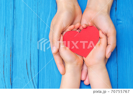 Child and dad hands holding red heart. Child and dad hands holding red heart. 70755767
