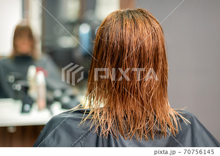 Back view of wet long red hair 70756145
