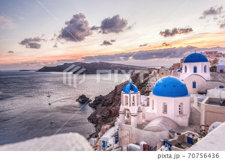 Oia village with churches against sunset on Santorini island in Greece 70756436