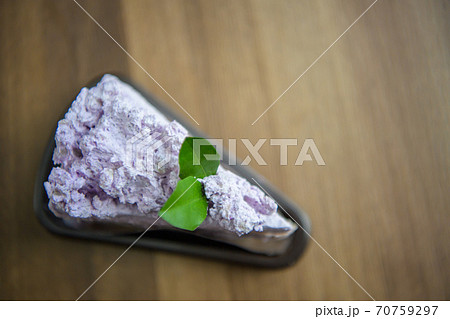 Taro flavor cake on the table in cafe. 70759297
