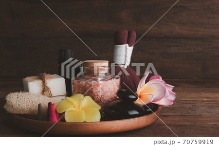 Spa products with organic soap luffa scrub compress ball,pink salt,black stones and beautiful flower on wooden tray isolated on white background with clipping path. Spa products with organic soap luffa scrub compress ball,pink salt,black stones and beautiful flower on wooden tray isolated on white background with clipping path. 70759919