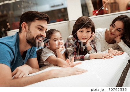 Young family lie on a sofa and try a sofa. Young family lie on a sofa and try a sofa. 70762536