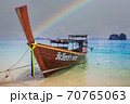 Longtail boat on beach in Thailand with rainbow 70765063