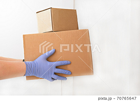 courier delivering boxes. hands holding box with food. courier delivering boxes. hands holding box with food. 70765647