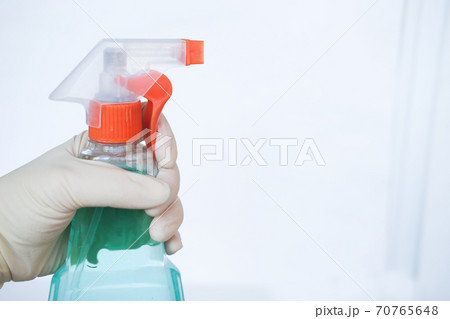 hand holding sprayer with detergent cleaning product. Home cleaning and Housekeeping concept.  70765648