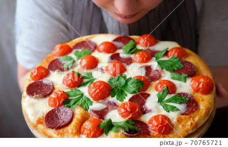 italian pizza Restaurant Menu. Pepperoni Pizza with Mozzarella cheese, salami, cherry tomatoes and cilantro.  70765721