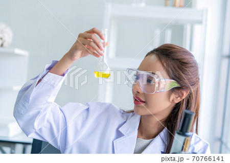 scientist woman lab technician assistant showing alcohol hand gel for cleaning hands at laboratory 70766141